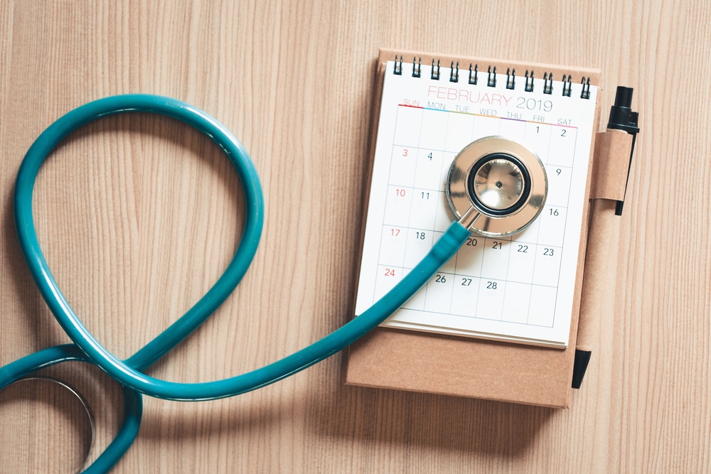 Top view of stethoscope on calendar for health checkup concept., Annual doctor appointment for physical check-up against wooden background., Healthcare Medicine and Insurance concept.